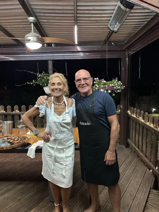 Enza and Antonio smiling near our table