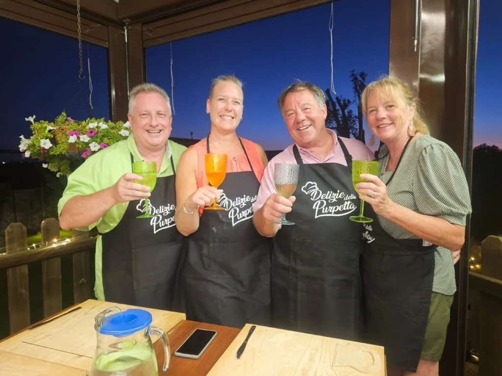 Some of our guests raising a toast around the table at our cooking class